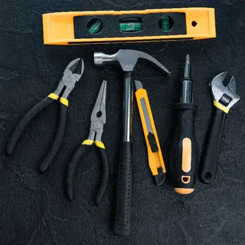 assorted hardware tools laid out for a repair job